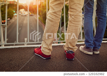 Together were on top of the world. Rearview shot of a couple standing together on a city bridge. Together were on top of the world. Rearview shot of a couple standing together on a city bridge. 120102982