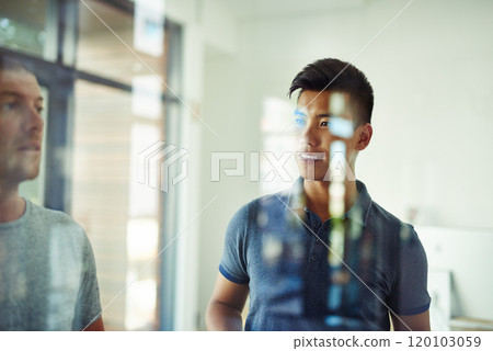 Planning is the first step. Cropped shot of a group of young designers planning on a glass board. 120103059