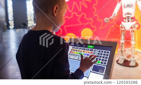 Children control a robot at a science fair using a tablet computer. Modern technologies and scientific education of children 120103266