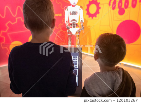 Children control a robot at a science fair using a tablet computer. Modern technologies and scientific education of children 120103267