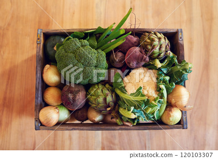 Take your pick of fresh vegetables. Shot of a variety of vegetables in a crate on a table. 120103307