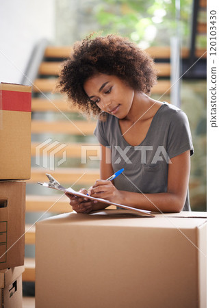 Heres to a new start. Shot of a young woman moving into her new house. 120103430