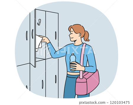 Woman visitor to gym stands near lockers for personal belongings and prepares for sports workout 120103475