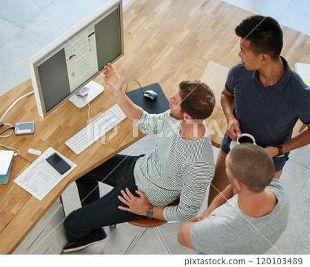Taking care of business. High angle shot of three designers working together on a project in an office. Taking care of business. High angle shot of three designers working together on a project in an office. 120103489