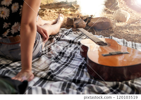 Ill play when the time is right. Shot of a woman sitting outside on a blanket next to a guitar. Ill play when the time is right. Shot of a woman sitting outside on a blanket next to a guitar. 120103519