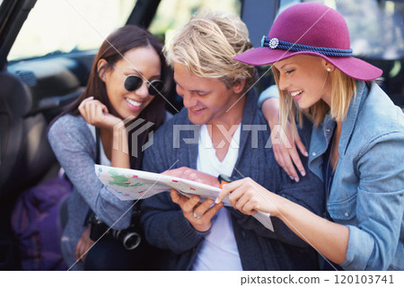 Lets turn getting lost into an adventure. Portrait of a group of friends leaning against their van, reading a map. Lets turn getting lost into an adventure. Portrait of a group of friends leaning against their van, reading a map. 120103741