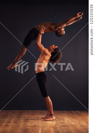 Together we can fly. Two male contemporary dancers performing a dramatic pose in front of a dark background. Together we can fly. Two male contemporary dancers performing a dramatic pose in front of a dark background. 120103836