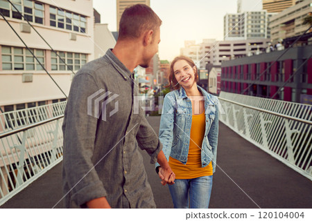 Enjoying a romantic stroll in the city. Shot of a happy young couple enjoying a romantic walk together in the city. Enjoying a romantic stroll in the city. Shot of a happy young couple enjoying a romantic walk together in the city. 120104004