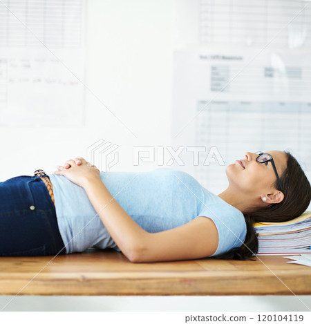 Another project done and dusted. Cropped shot of a smiling young businesswoman lying on her desk with paperwork on it. 120104119