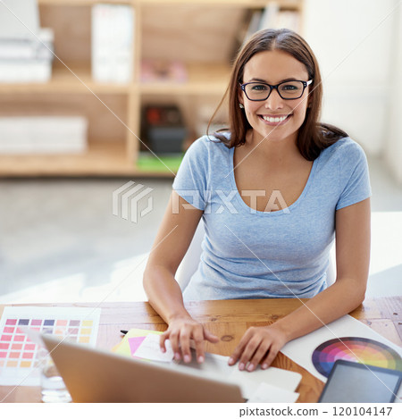 Excited about this project. Portrait of a female designer working on a project at her desk. 120104147
