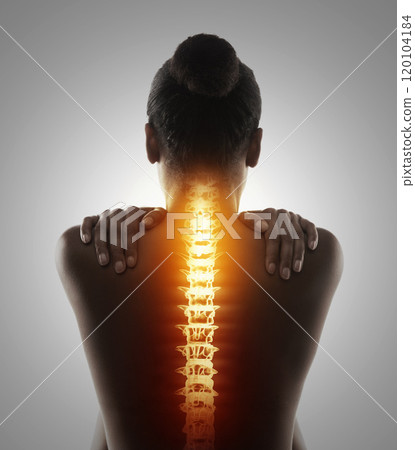 Targeting the pain. Rearview shot of a woman holding her back in pain. 120104184