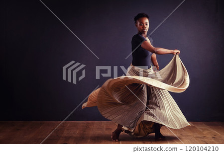 Feel the motion. Female contemporary dancer in a dramatic pose against dark background. Feel the motion. Female contemporary dancer in a dramatic pose against dark background. 120104210