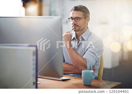 Always thinking of something new...Cropped shot of a businessman working at his desk. 120104401
