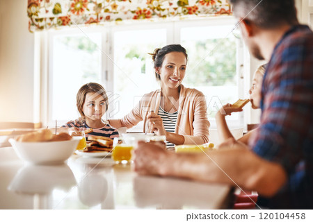 She makes sure that everyone has something to eat. Cropped shot of a family enjoying breakfast together. 120104458
