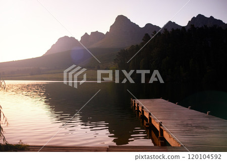 Enjoy the tranquility. A pier leading to a tranquil lake. 120104592