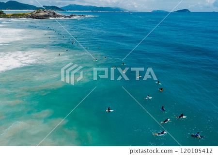 Surfers on surfboards in ocean waiting wave in Floripa. Aerial view in Brazil 120105412