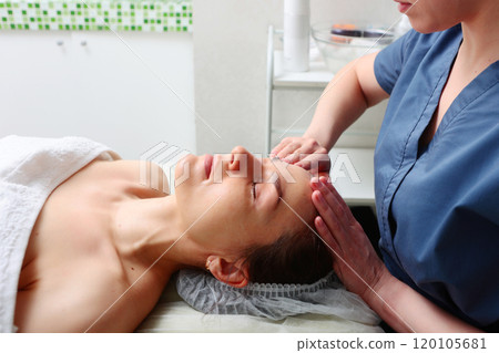 Face massage. Young woman in beauty salon. Spa skin and body care. Facial beauty treatment. Cosmetology. 120105681