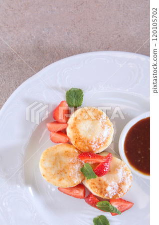 Cottage cheese pancakes, cheesecakes, pancakes with strawberries and jam. Healthy and dietary breakfast. Cottage cheese pancakes, cheesecakes, pancakes with strawberries and jam. Healthy and dietary breakfast. 120105702