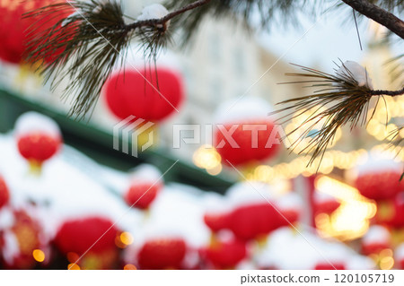 Red Chinese lanterns in the snow are out of focus. Chinese New Year. Background for a New Year's card. Out of focus. Red Chinese lanterns in the snow are out of focus. Chinese New Year. Background for a New Year's card. Out of focus. 120105719