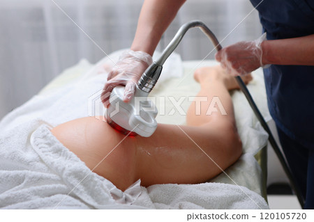 Anti-cellulite massage with an ultrasound machine of the hip area. Hardware rejuvenation of the body. RF-lifting procedure. Hardware cosmetology. Anti-cellulite massage with an ultrasound machine of the hip area. Hardware rejuvenation of the body. RF-lifting procedure. Hardware cosmetology. 120105720