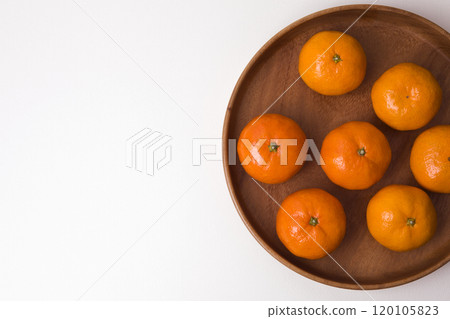 Tangerines on a plate on white background Tangerines on a plate on white background 120105823