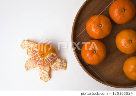 Tangerines on a plate on white background 120105824