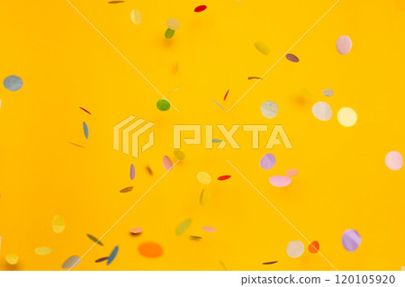 Colorful of confetti on gold background. Brilliant colored sequins. Holiday greeting card.  120105920