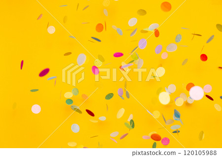 Colorful of confetti on gold background. Brilliant colored sequins. Holiday greeting card.  120105988