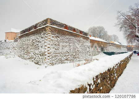 uzhhorod, ukraine - 12 JAN 2013: uzhhorod castle in winter. popular landmark in western ukraine. cloudy weather. snow covered walls and bastion uzhhorod, ukraine - 12 JAN 2013: uzhhorod castle in winter. popular landmark in western ukraine. cloudy weather. snow covered walls and bastion 120107786