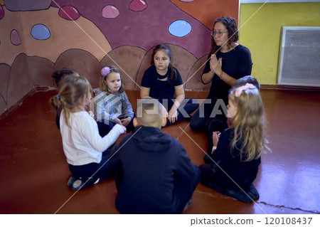 5-7 year old children sit in a circle at an acting class, extracurricular activities 5-7 year old children sit in a circle at an acting class, extracurricular activities 120108437