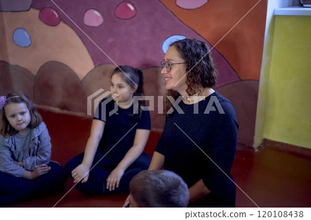 5-7 year old children sit in a circle at an acting class, extracurricular activities 5-7 year old children sit in a circle at an acting class, extracurricular activities 120108438