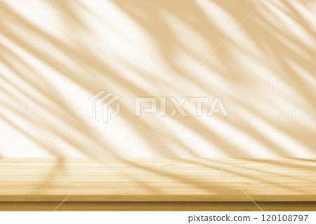 Empty wood table top on beige wall texture with tree leaves shadow background Empty wood table top on beige wall texture with tree leaves shadow background 120108797