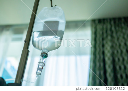 Close up medical intravenous IV drip in hospital background 120108812