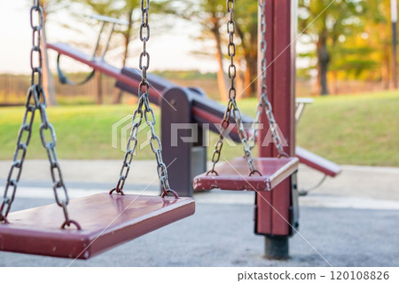 Empty chain swing in the playground Empty chain swing in the playground 120108826