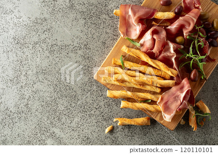 Italian prosciutto with bread sticks, olives, and rosemary. Italian prosciutto with bread sticks, olives, and rosemary. 120110101