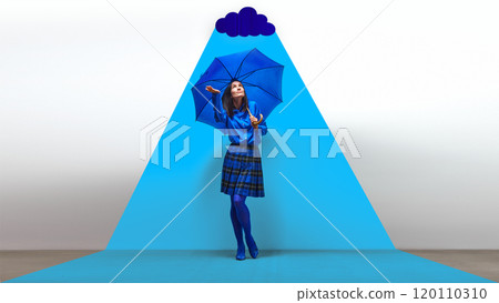 Woman in blue with umbrella standing under bright blue spotlight with cloud. Self-reflection, and emotional protection. Contemporary art collage. 120110310