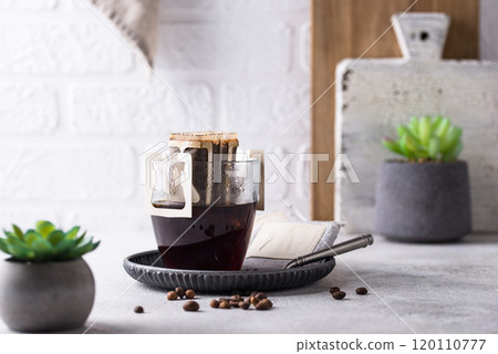 Freshly brewed drip coffee in glass cup Freshly brewed drip coffee in glass cup 120110777
