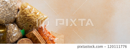 Essential home food stock for military operations and crises and for the period of quarantine and isolation, canned food, pasta, flour and nonperishable items,the concept of stay at home, banner Essential home food stock for military operations and crises and for the period of quarantine and isolation, canned food, pasta, flour and nonperishable items,the concept of stay at home, banner 120111776