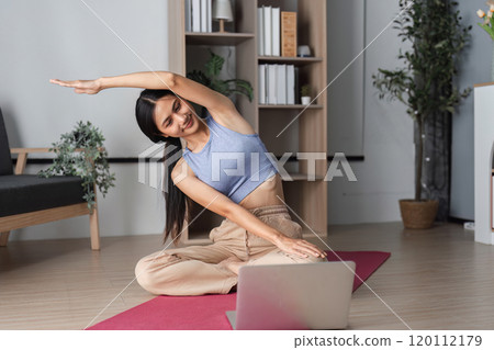 Healthy Woman Practicing Yoga at Home for Wellness and Relaxation in a Modern Living Space with Natural Light and Indoor Plants 120112179