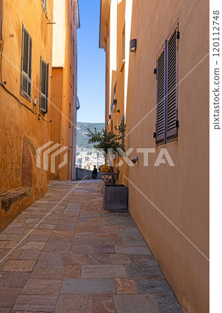 Quiet alley in an old Corsican mountain village with stone walls and rustic architecture 120112748