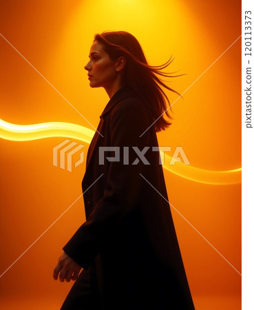 Elegant silhouette of confident woman in motion against vibrant abstract orange background Elegant silhouette of confident woman in motion against vibrant abstract orange background 120113373