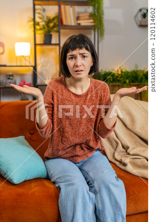 Confused woman raising hands asking why, what reason of failure, demonstrating disbelief irritation Confused woman raising hands asking why, what reason of failure, demonstrating disbelief irritation 120114602