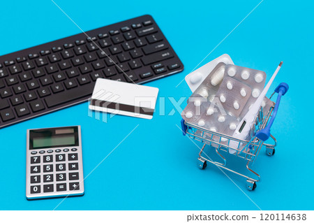Ordering Medicines. Pills and Capsules in a Shopping Cart on Blue Background Ordering Medicines. Pills and Capsules in a Shopping Cart on Blue Background 120114638