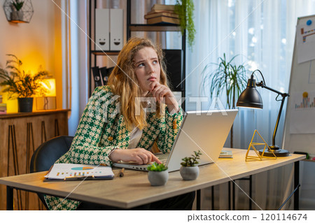 Bored sleepy businesswoman worker working on laptop computer yawns leaning on hand at office desk 120114674