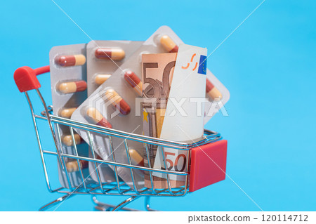 Pills and Capsules in Shopping Cart on Blue Background 120114712
