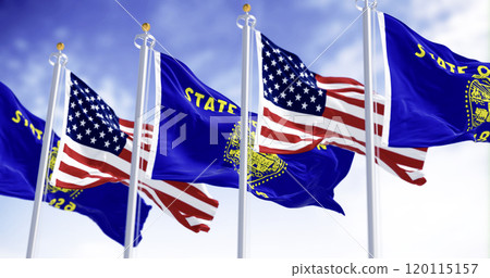 Oregon state flags waving in the wind with the american flags on a clear day 120115157