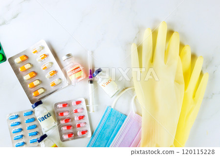 Vaccine vial, pills, syringe, face mask constitute medical supplies used to prevent disease illness. 120115228