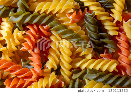 Uncooked Vibrant Colored Fusilli Pasta Background Uncooked Vibrant Colored Fusilli Pasta Background 120115283