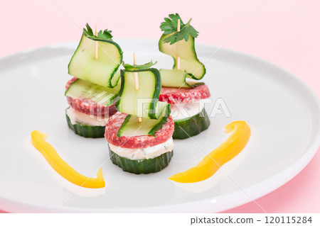 Canapes without Bread with Salami, Cucumber, Greens and Cream Cheese on White Plate Canapes without Bread with Salami, Cucumber, Greens and Cream Cheese on White Plate 120115284