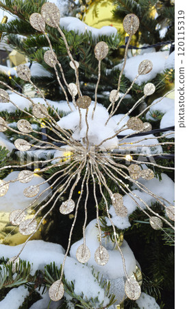 Branches of Christmas tree with beautiful decorations covered with snow 120115319